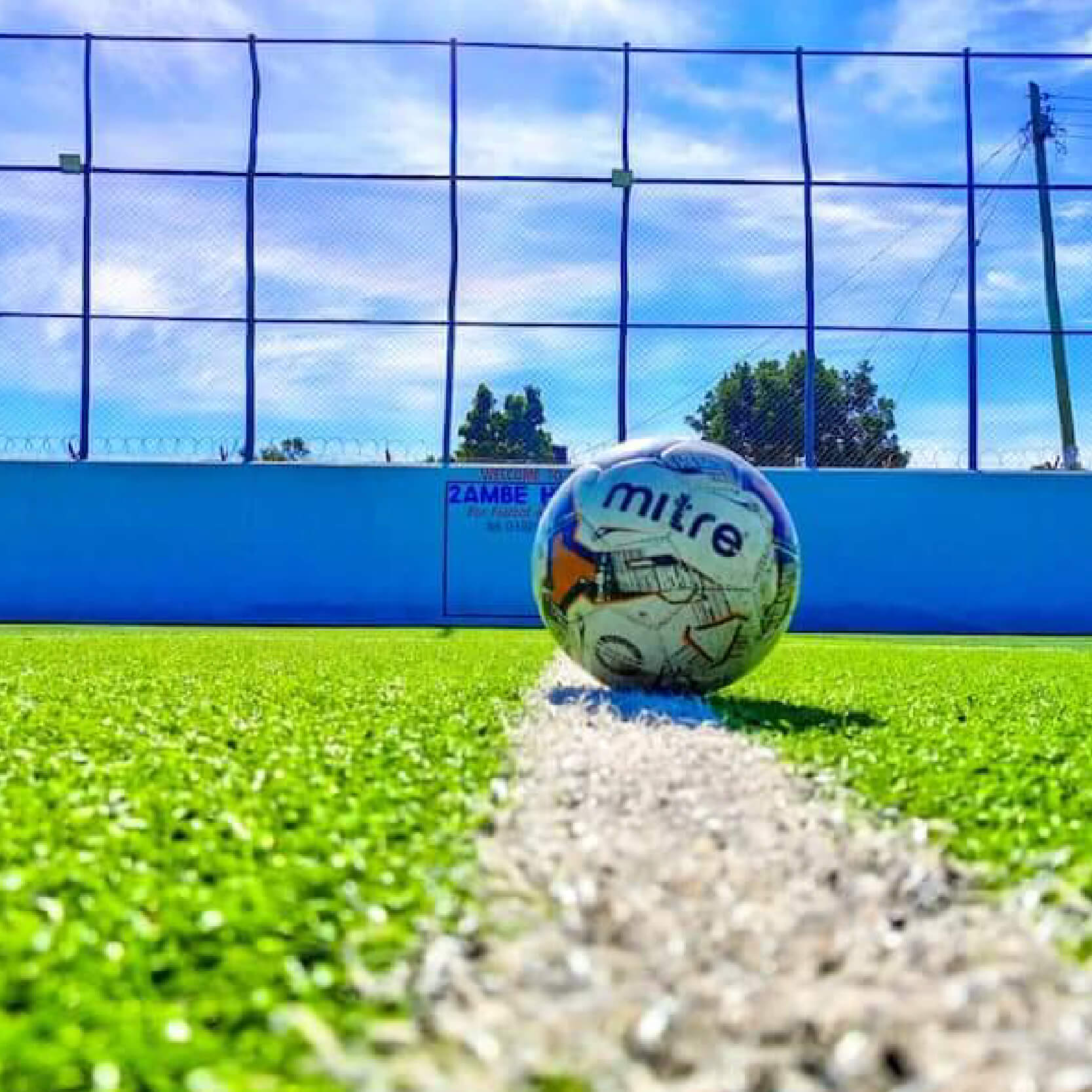 image 1 and 2 are of an artificail turf playing ground with soccer ball, image of artificial playing turf with soccer ball and image 3 is a trophy with golden boot and golden glove by its sides